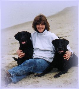Deb Mag, manager of a shelter in Monterey County, California, relaxes with Sidni and Charlie after a long run. 